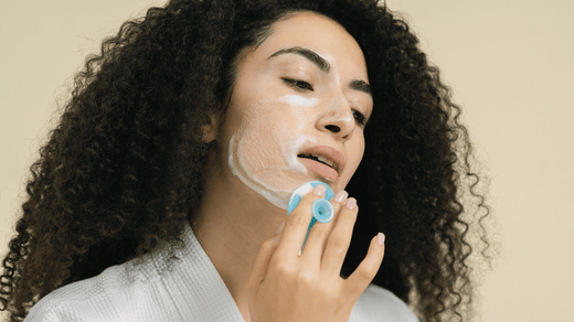 A middle-aged woman demonstrates how to use facial cleanser