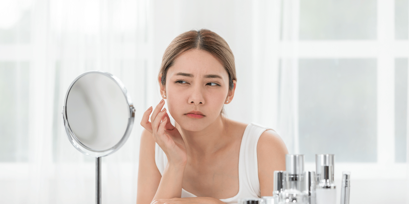 A young woman is wondering what causes dry skin on face
