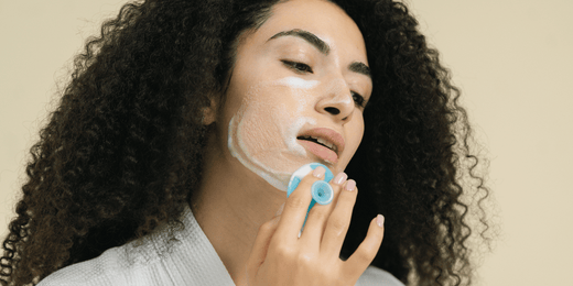 A middle-aged woman demonstrates how to use facial cleanser