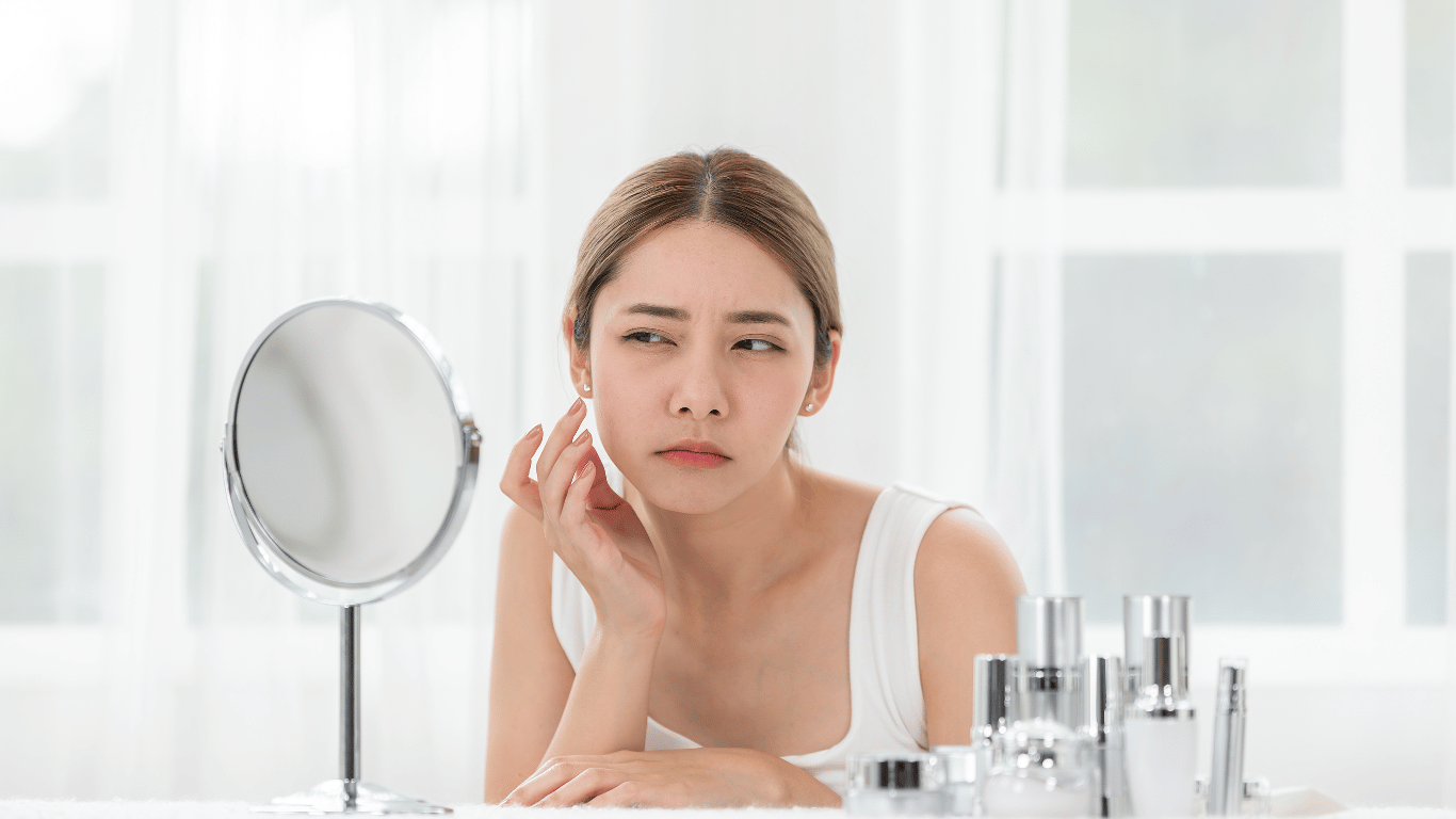 A young woman is wondering what causes dry skin on face
